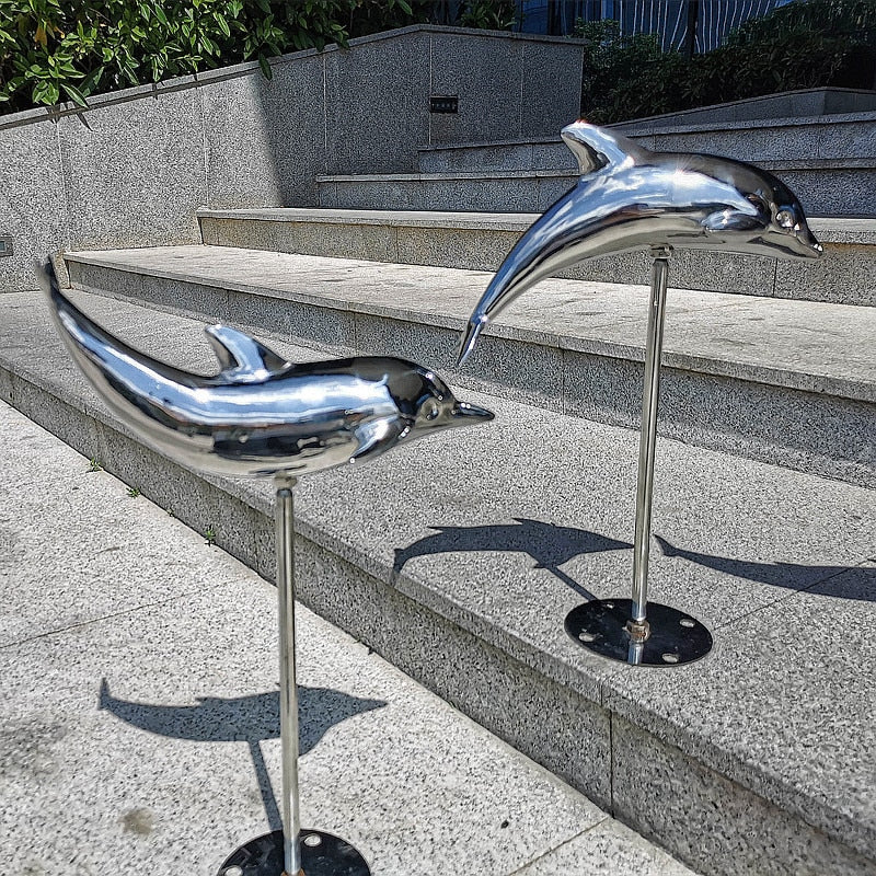 outdoor concrete dolphin statues