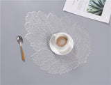 white tea cup and leaf mats
